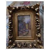 2 smaller pictures in designed frame gold in color