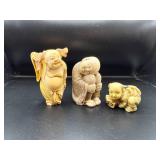 Three Carved Figurines of Various Designs