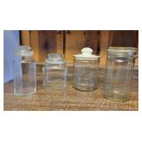 Four Glass Storage Jars