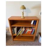 Wooden Shelf With Assorted Books and Lamp