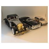 Three Die-Cast Model Cars of Varying Eras