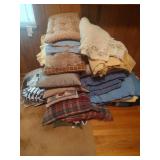 Assortment of Pillows and Blankets