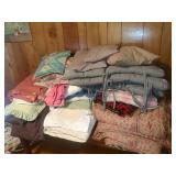 Assortment of Pillows and Blankets