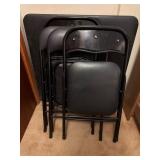 Black Folding Table with Four Folding Chairs