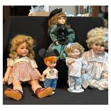 Five Dolls in Varied Attire and Sizes