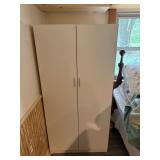 White Storage Unit with Clothing Contents