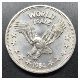 1984 WORLD TRADE ROUND - 1 OZ SILVER