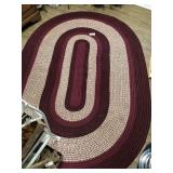 Maroon oval braided rug