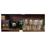 Shelf full of stem glasses, coca cola ++
