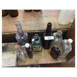 8 Antique Whiskey Bottles-Two Have Writing on Them