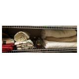 Shelf of Holiday décor and blankets