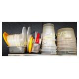 Stacked Plastic Containers and Metal Trays in Vari