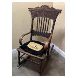 ANTIQUE PRESSED BACK ROCKER WITH NEEDLEPOINT DOG