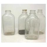 4 vintage half gallon juice bottles.