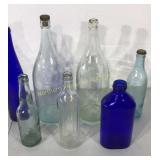 Seven antique glass bottles