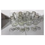 Eight clear glass mason jars with bails