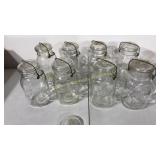 Eight clear glass ball mason jars with bails