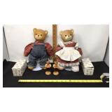 Two porcelain bear dolls on stands and two wooden