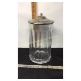 Heavy glass jar w/ hinged metal lid.