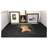 3 framed pictures and one clown painting which is