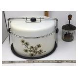 Vintage cake storage tin and glass chopper.