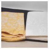 2 tablecloths, yellow and white.