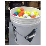 5-gallon bucket of golf balls.