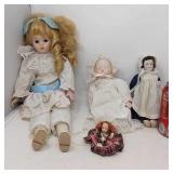 4 Porcelain dolls.