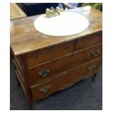 Oak chest of drawers converted into a sink.