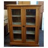 Oak jelly cabinet with glass doors.