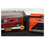 2 Diecast cars in boxes.