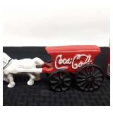 Cast iron Coca-Cola wagon pulled by a horse.