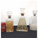 3 vintage liquor bottles.