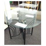 Metal frame glass top patio table. Approximately