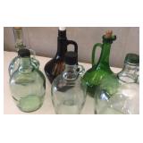 Six glass bottles with handles, one brown,