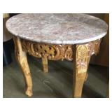 Oval marble top in table with carved wood base