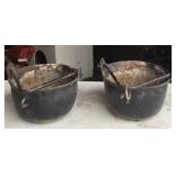 Two small cast iron pots with bails.