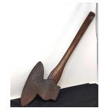 Primitive broad axe with wooden handle.