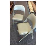 2 Cushioned seat and back folding chairs.