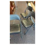 3 cushioned seat folding chairs with metal backs.