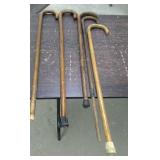 5 wooden walking canes.