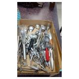 Assorted kitchen utensils and flatware.