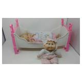 2 dolls and a doll bed