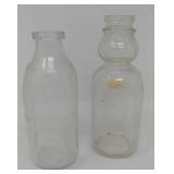 2 milk bottles one with cream separator