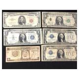 5 US Paper currency, and one Saudi Arabian Riyal.