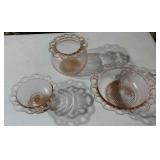 3 pieces of pink depression glass. One piece has