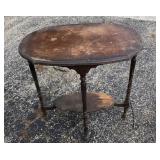 Antique occasional table has four legs, top is