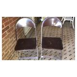 Two metal folding chairs