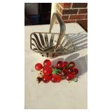 Metal basket with glass cherries.