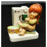 1975 Goebel Girl Washing Clothes at a Laundromat